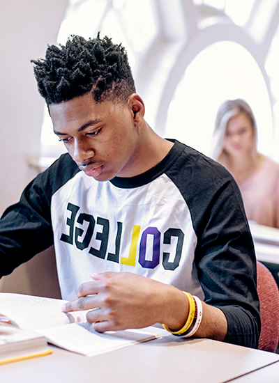 A male student studies in class.